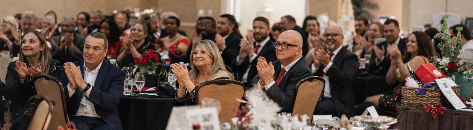 Guests staying engaged during a gala program hosted by a corporate emcee
