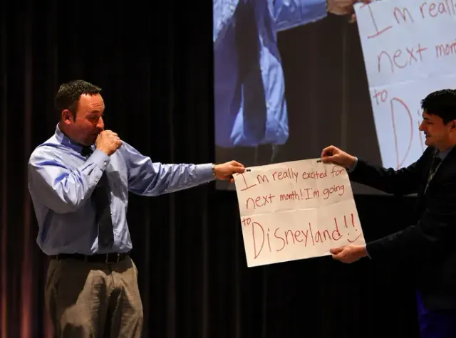 Memphis magician Josh Weidner revealing a written prediction on stage with a volunteer